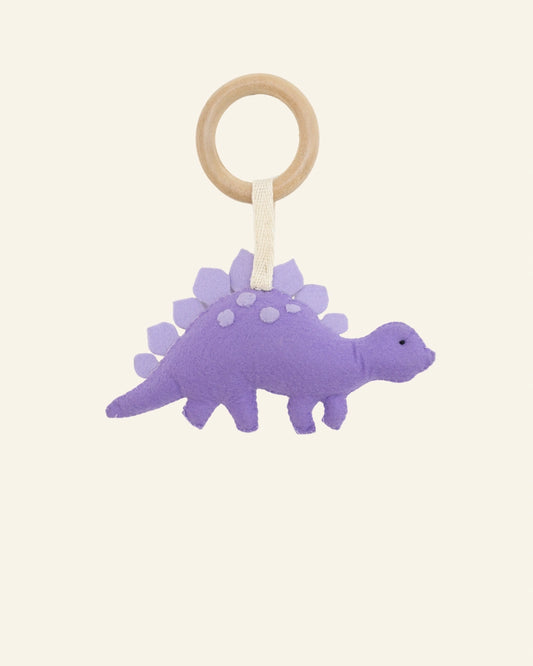 Full view of Dodo Spike soft felt dinosaur hanging toy featuring a secure wooden attachment ring, perfect for newborn sensory stimulation, stroller accessories, and baby gifting.