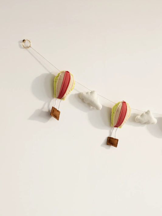 Close-up of the left side of the Up and Away felt banner showcasing handcrafted hot air balloons and soft cloud accents.