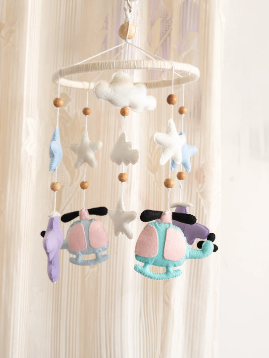 Fly High handcrafted felt baby crib mobile featuring airplanes, helicopters, clouds, stars, and moon accents for dreamy aviation-themed nursery décor.