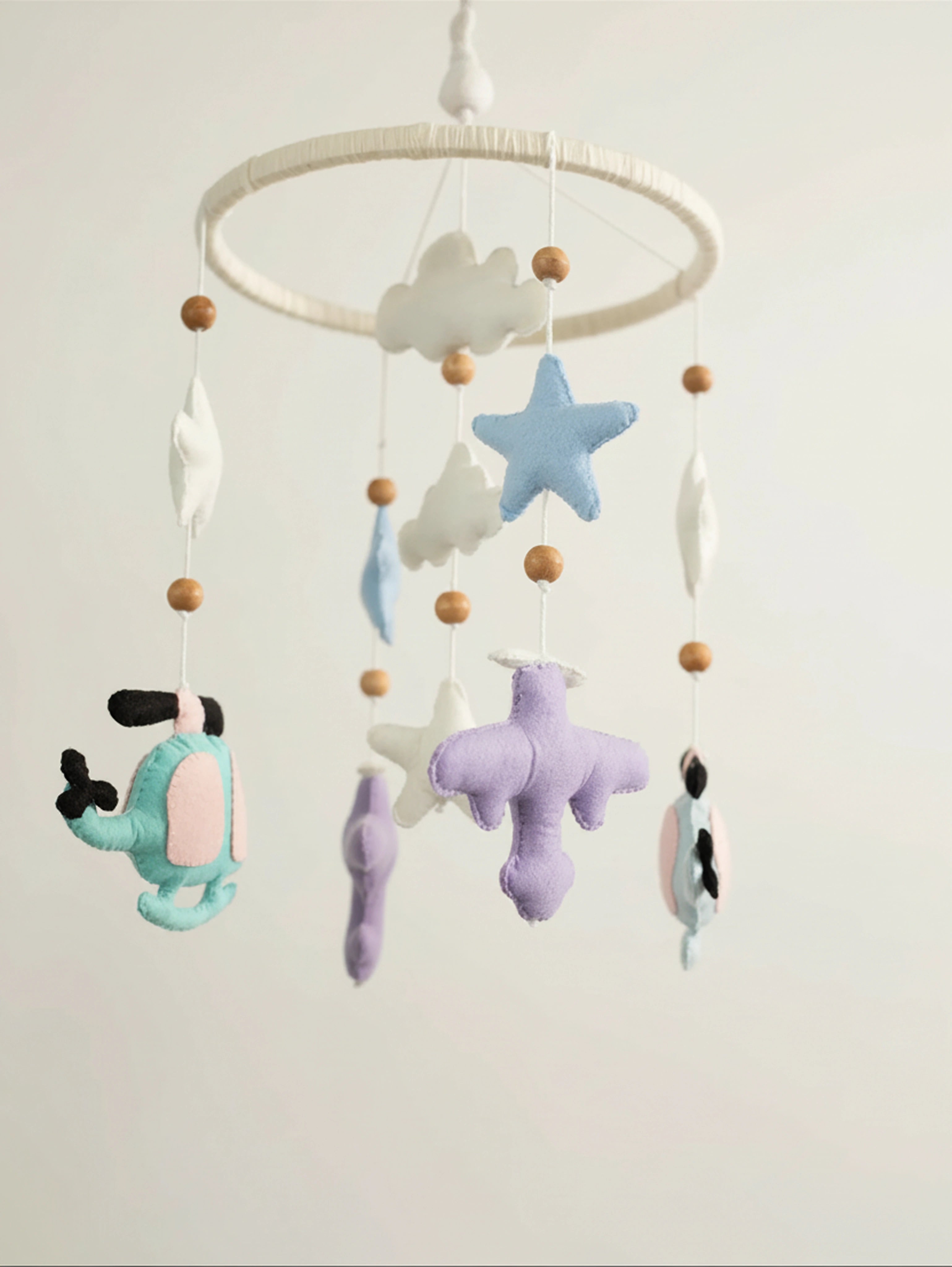 Fly High premium handcrafted felt baby mobile with pastel helicopters, airplanes, clouds, stars, and moon, beautifully styled for elegant nursery décor.