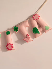 Detailed view of the Garvita handcrafted felt name banner featuring floral appliqués, leafy accents and premium stitched pastel letters.