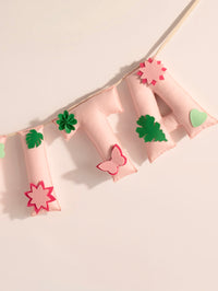 Detailed view of the Garvita handcrafted felt name banner featuring floral appliqués, leafy accents and premium stitched pastel letters.