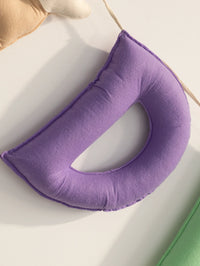 Close-up of a handcrafted purple felt letter "D" from a personalized baby name banner, featuring soft premium felt fabric and fine handmade detailing for nursery decor.
