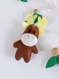 Handcrafted felt moose with soft antlers from the Into the Wild crib mobile, designed for cozy woodland-inspired baby room décor.