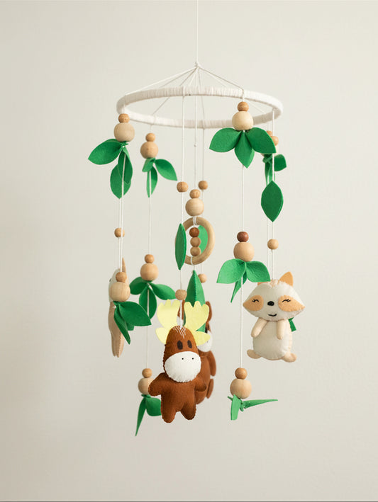 Into the Wild premium handcrafted felt baby cot mobile featuring woodland animals, natural wooden elements, and forest leaves for elegant nursery décor.