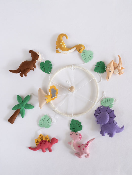 Complete Roar Away handcrafted felt dinosaur cot mobile showcasing colorful dinosaurs, tropical leaves, volcano, palm tree, and jungle-inspired nursery décor.