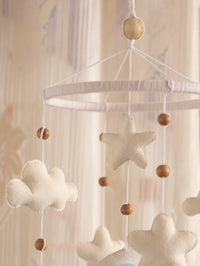 Close-up of the Sleep Tight nursery cot mobile with plush clouds, felt stars, natural wooden beads, and handcrafted hanging details for a dreamy baby room.