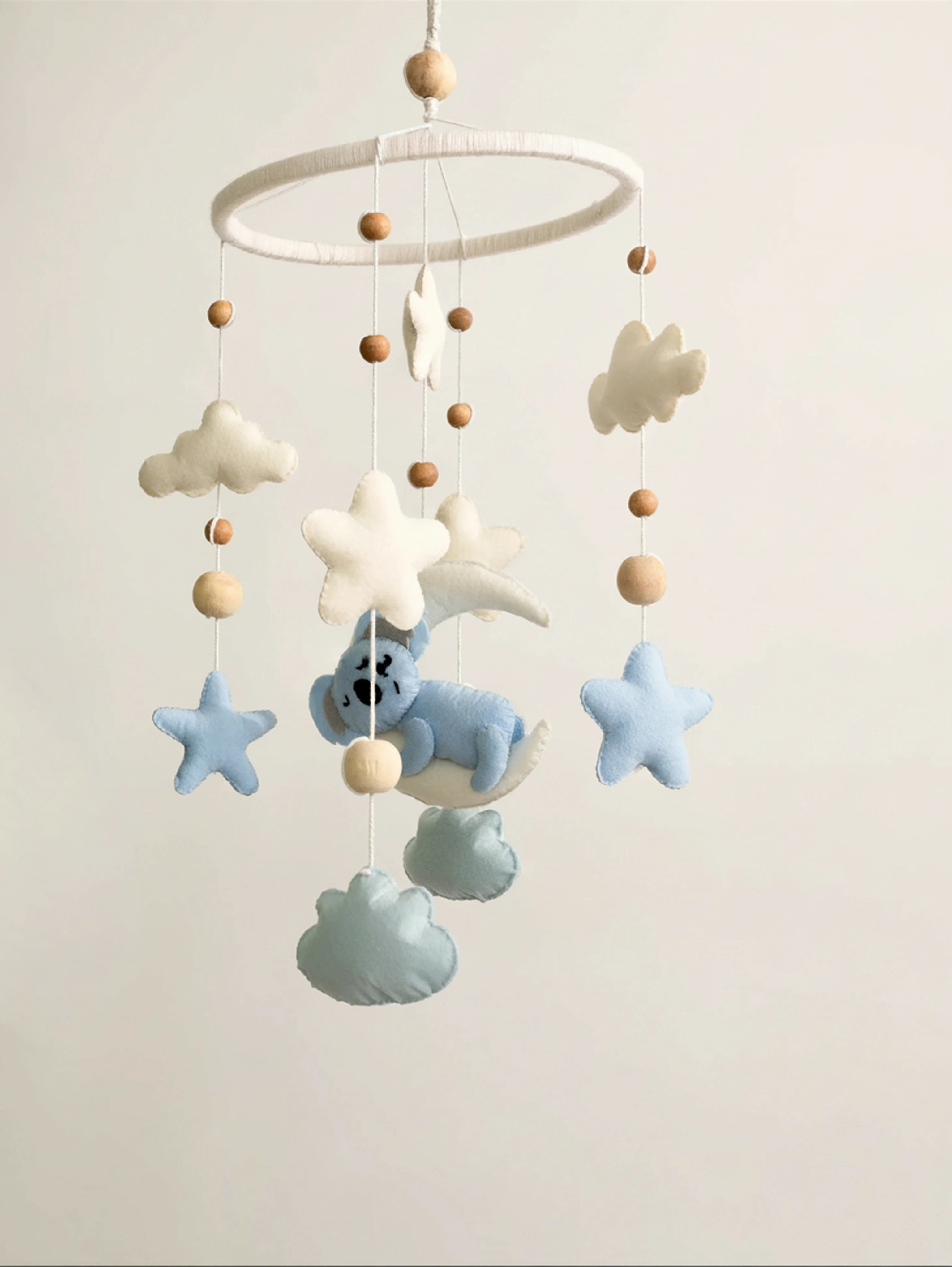 Sleep Tight premium handcrafted baby cot mobile featuring a sleeping koala, fluffy clouds, soft stars, crescent moon, and wooden bead accents for modern nursery styling.