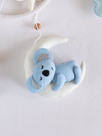 Adorable handcrafted sleeping koala on a crescent moon from the Sleep Tight baby mobile, designed to create a calm and comforting nursery atmosphere.