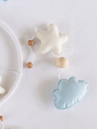 Soft handcrafted star and cloud ornaments from the Sleep Tight crib mobile with natural wooden beads, adding gentle bedtime charm to baby nursery décor.