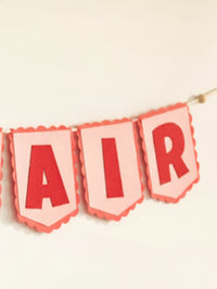 Close-up of the ‘AIR’ section of the personalized Nirvair felt name banner with premium handcrafted detailing