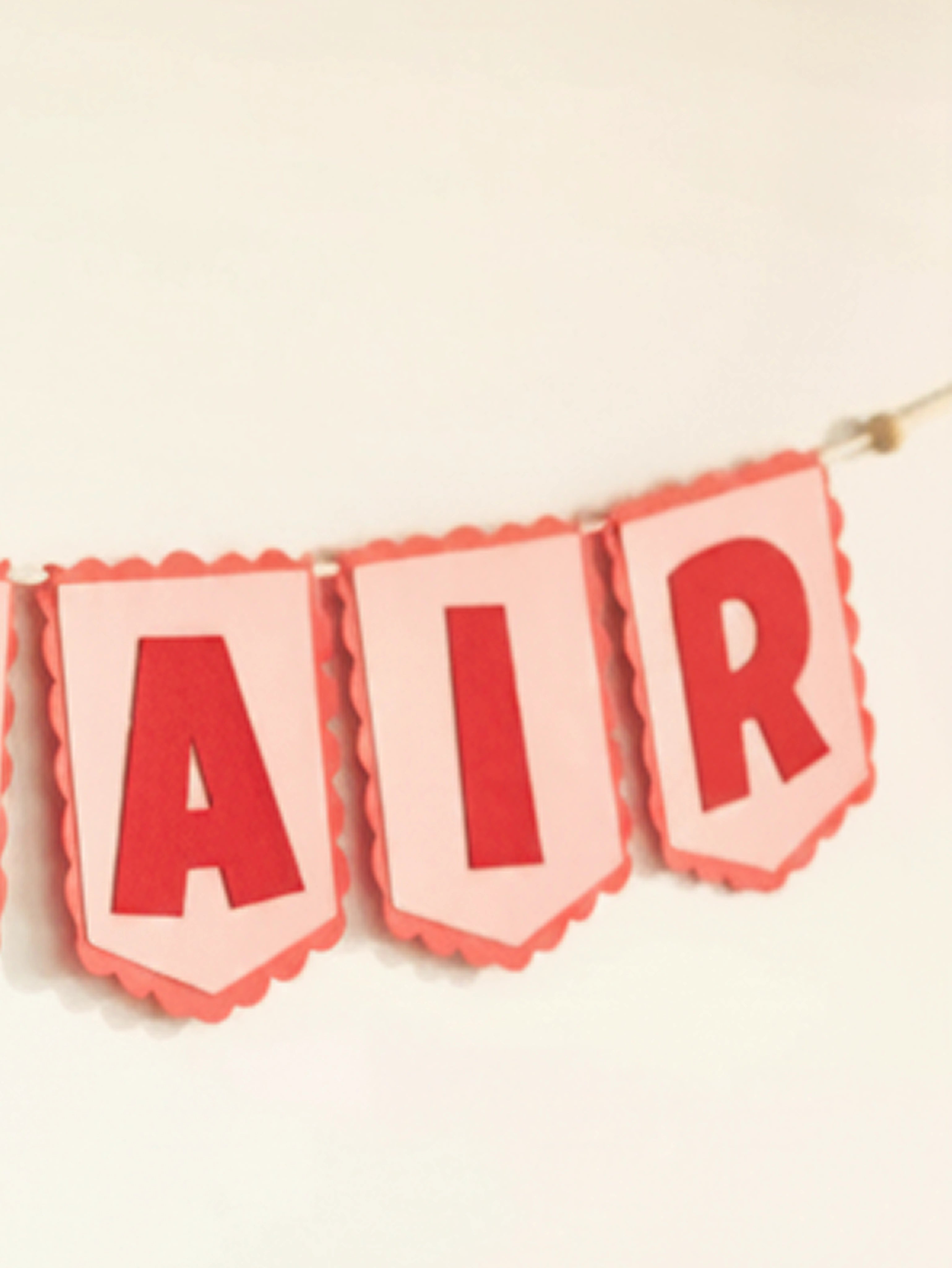 Close-up of the ‘AIR’ section of the personalized Nirvair felt name banner with premium handcrafted detailing