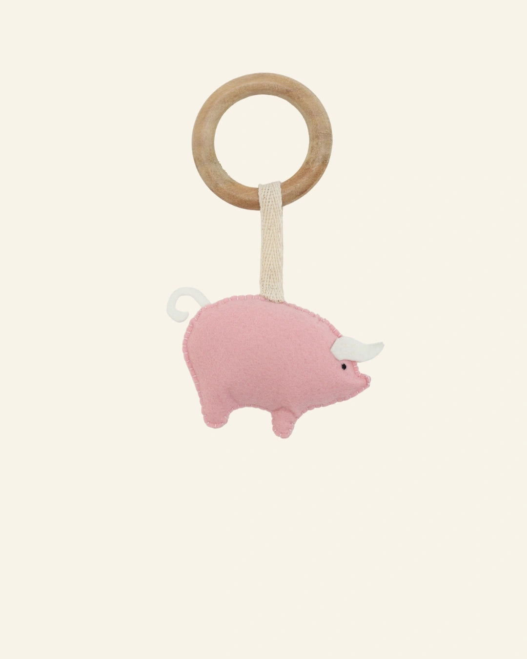 Hanging view of the Pigsy felt pig teether ring crafted with premium felt and a polished wooden ring, making it a thoughtful newborn gift and nursery essential.