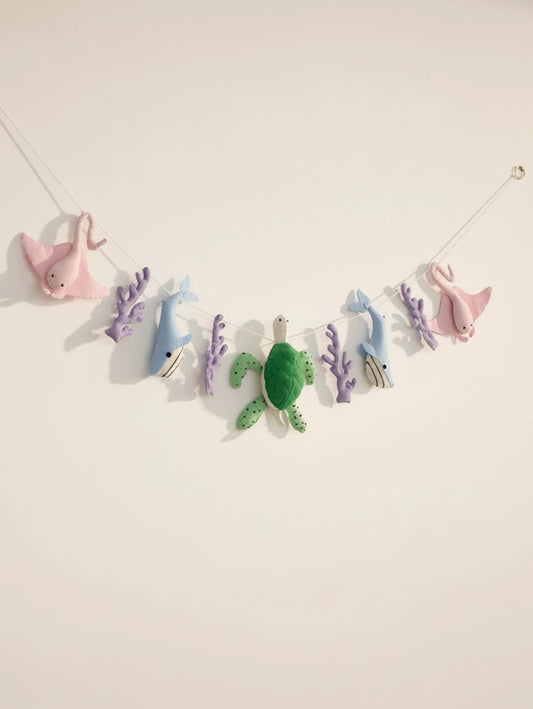 Full view of the Under the Sea handcrafted felt nursery banner featuring stingrays, whales, sea turtles and coral for ocean-themed baby room decor.