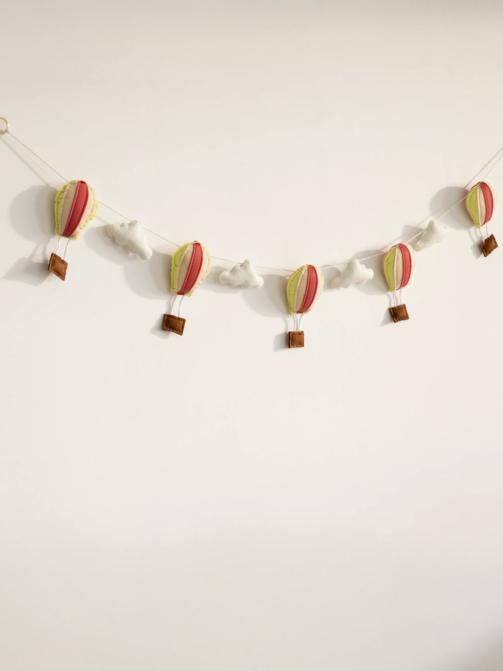 Full view of the Up and Away handcrafted felt nursery banner featuring colorful hot air balloons and fluffy clouds for baby room wall decor.