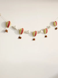 Full view of the Up and Away handcrafted felt nursery banner featuring colorful hot air balloons and fluffy clouds for baby room wall decor.