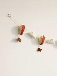 Close-up of the left side of the Up and Away felt banner showcasing handcrafted hot air balloons and soft cloud accents.