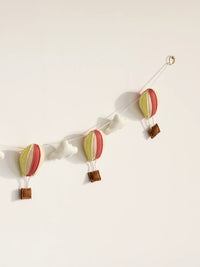 Detailed right-side view of the Up and Away nursery wall hanging with pastel hot air balloons and plush white clouds.